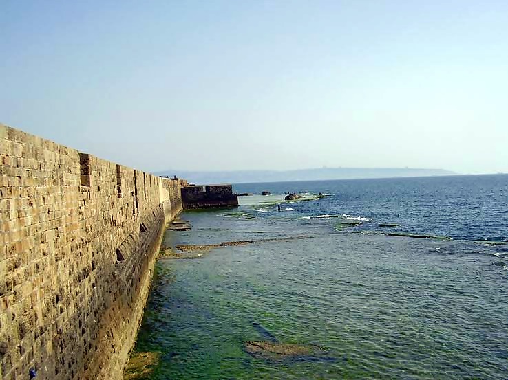 A view of the western walls of the old city of Acre. Mount Carmel and Haifa are seen in the background